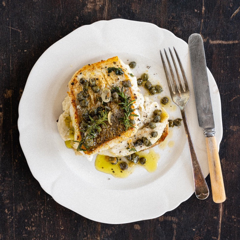 Lightly salted hake bruschetta with capers, rosemary, garlic and cauliflower purée