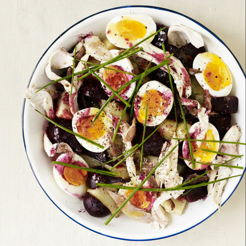 Cold roast chicken with early new potatoes, baby beetroot, eggs, anchovies and chives