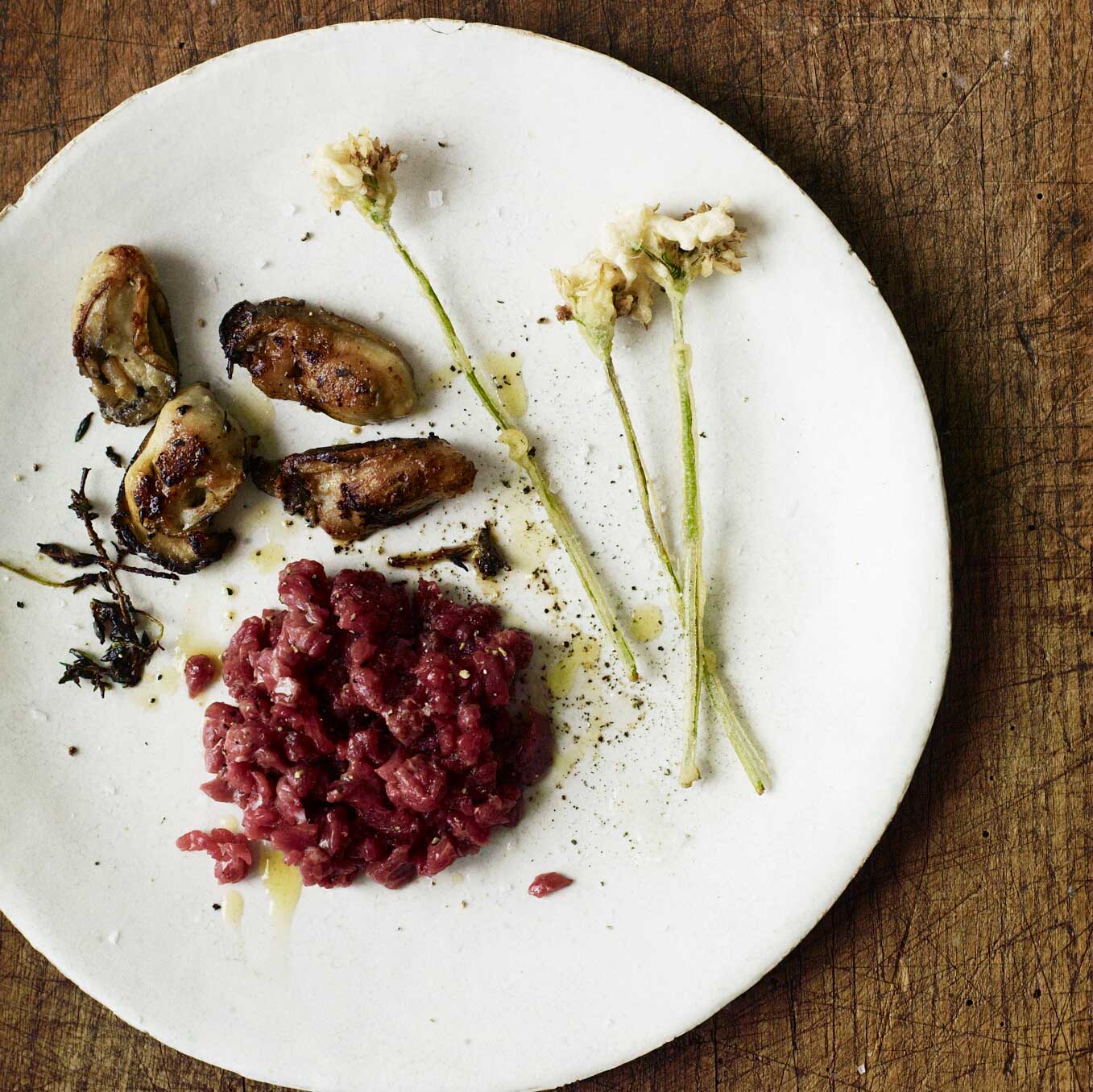 Mutton tartare with pan-roasted oysters & wild garlic flowers