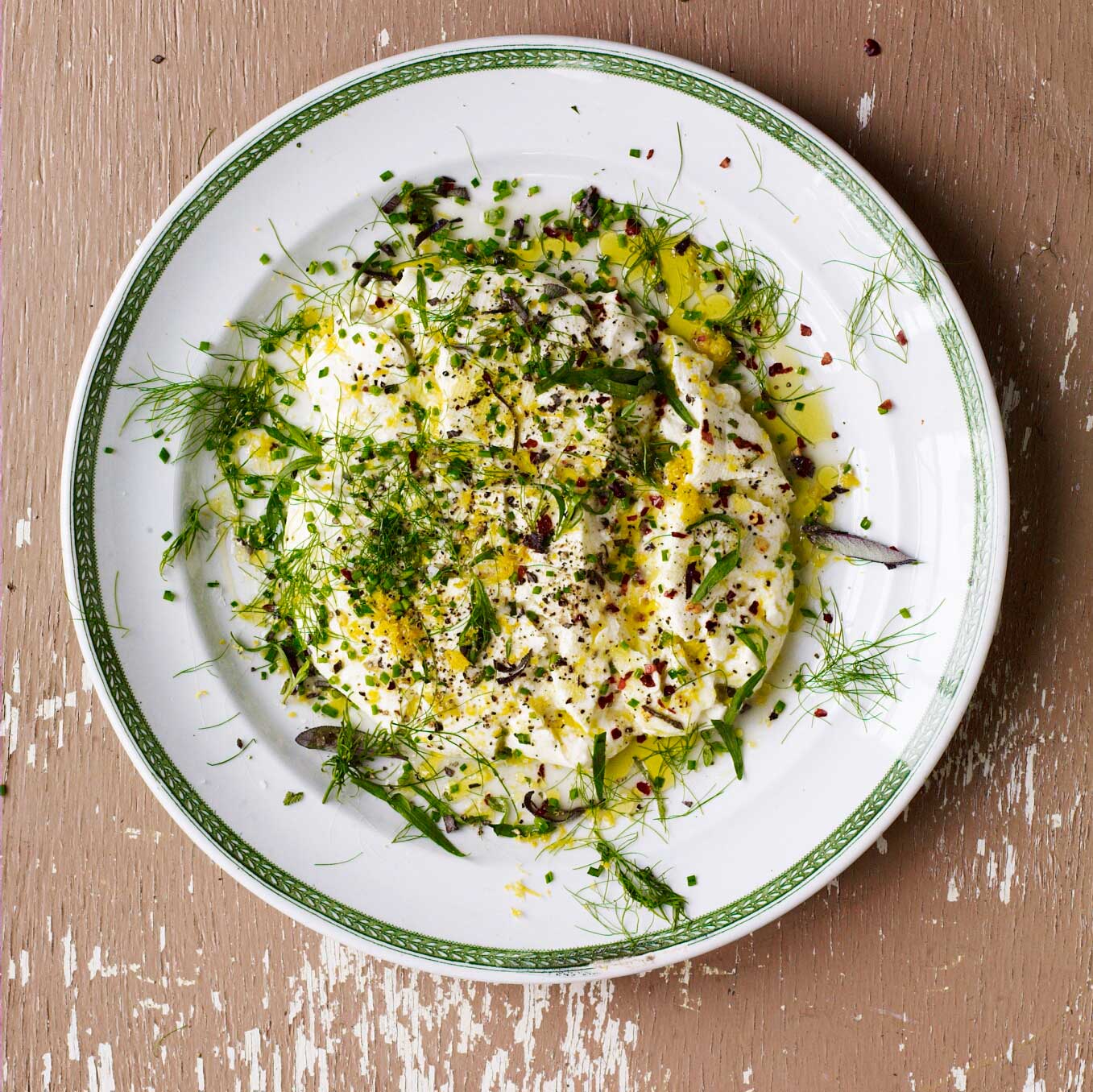 Homemade cheese with herbs, lemon & olive oil