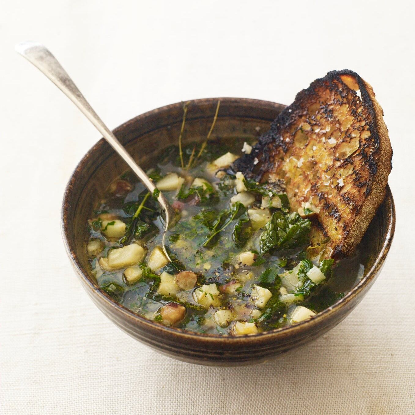 Cobnut & celeriac soup with kale, parsley & olive oil