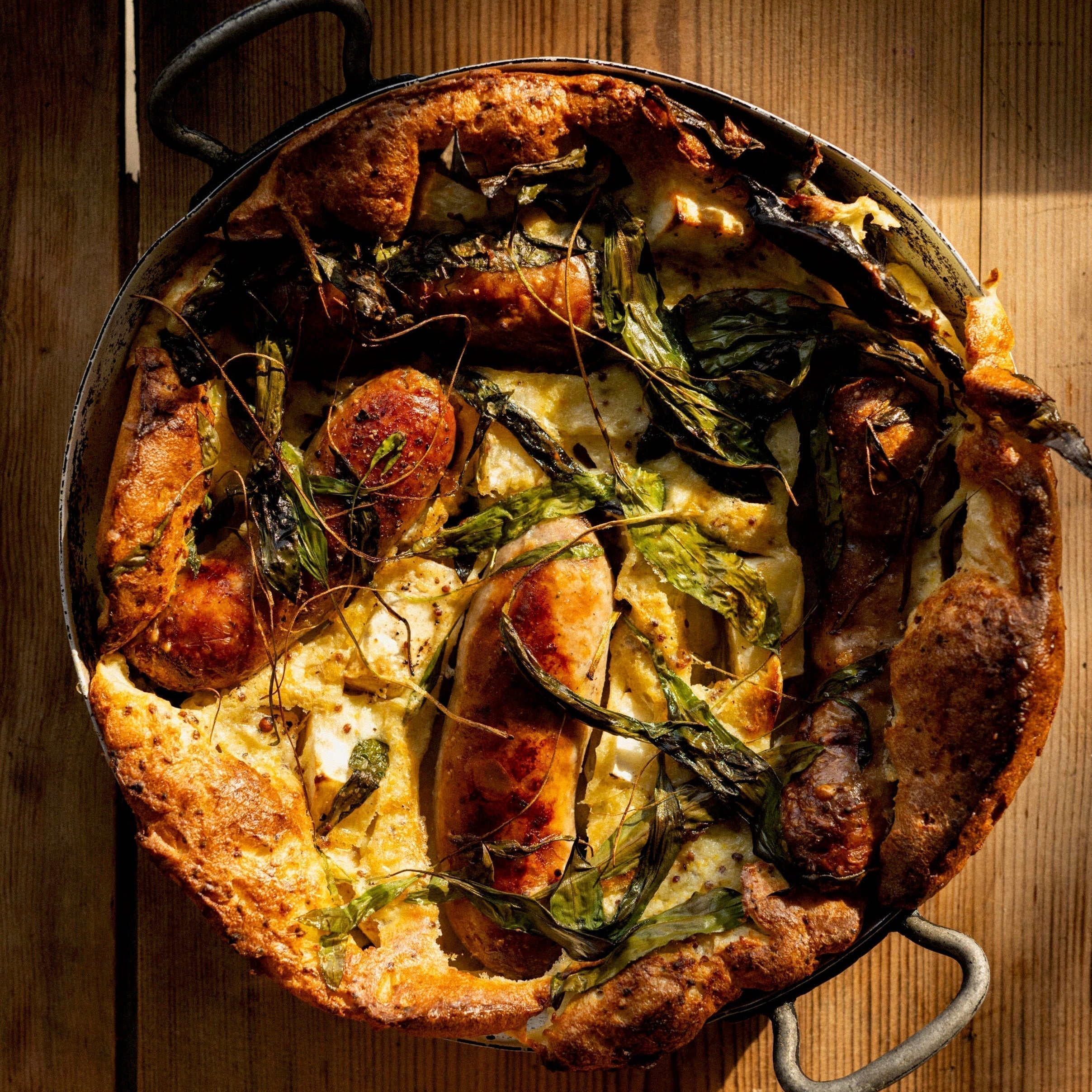 Toad in the hole with sausages, celeriac and wild garlic