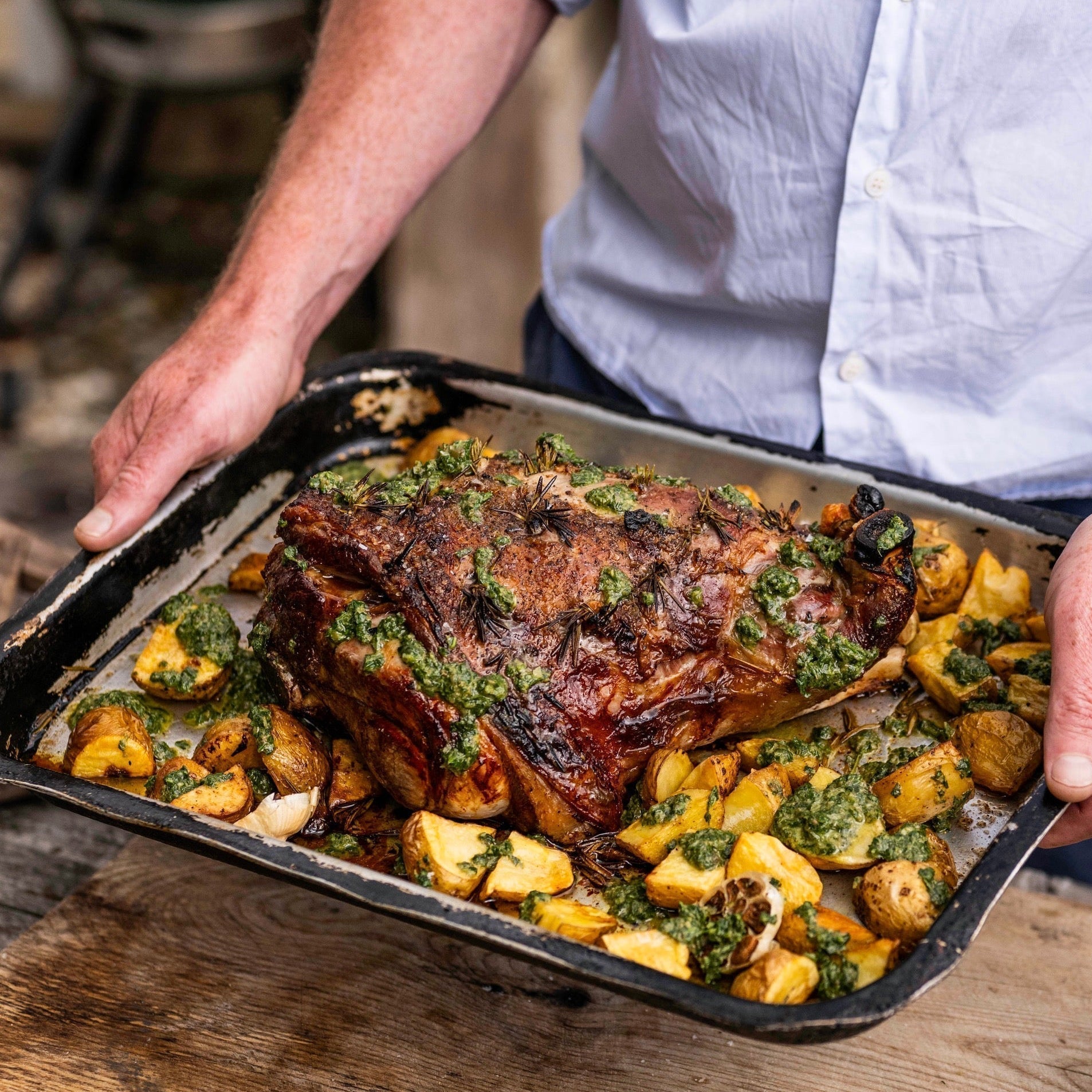 Roast leg of hogget with new potatoes, rosemary, garlic and green herb sauce
