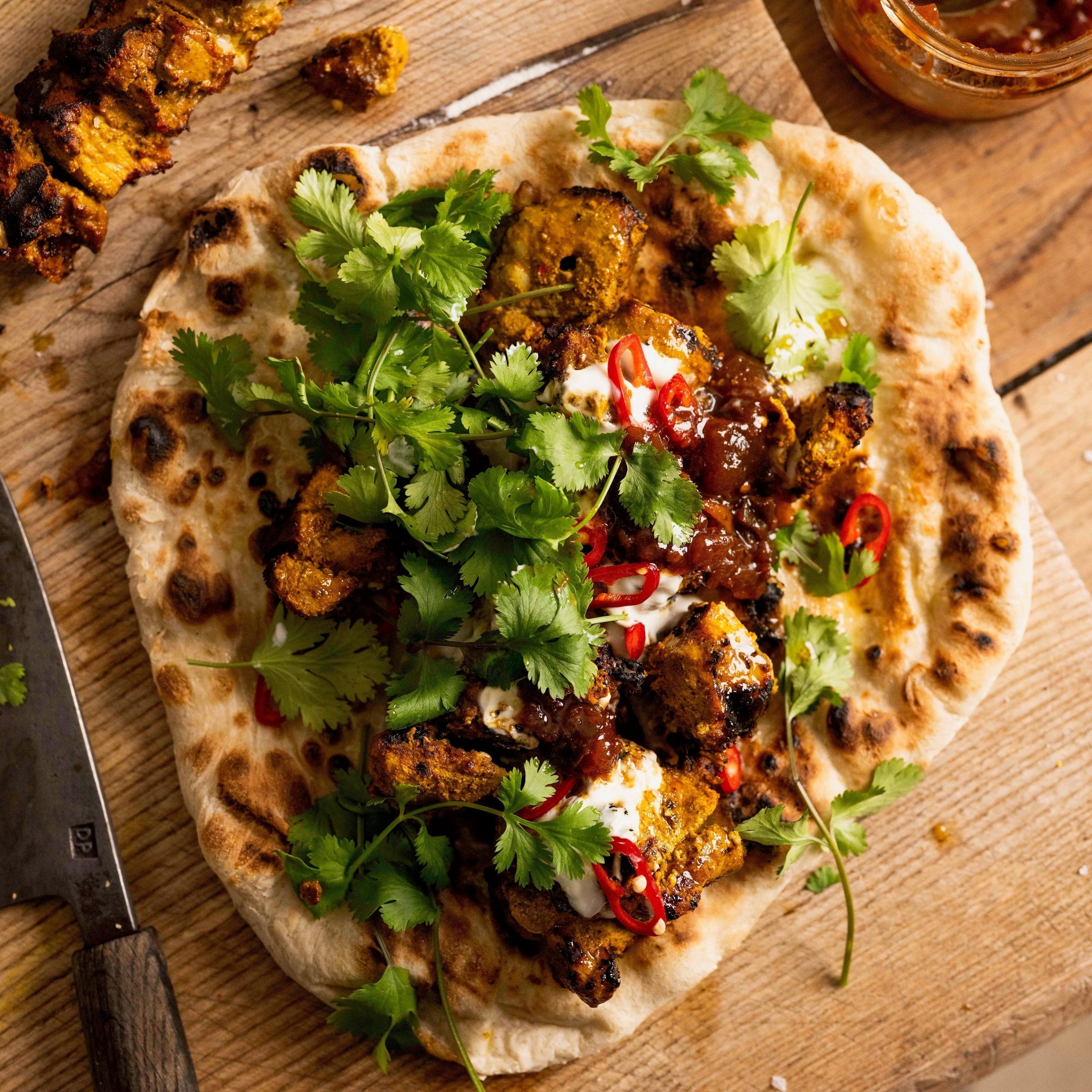 Tandoori pork kebabs charred and served with warm flatbreads, yogurt and fresh coriander