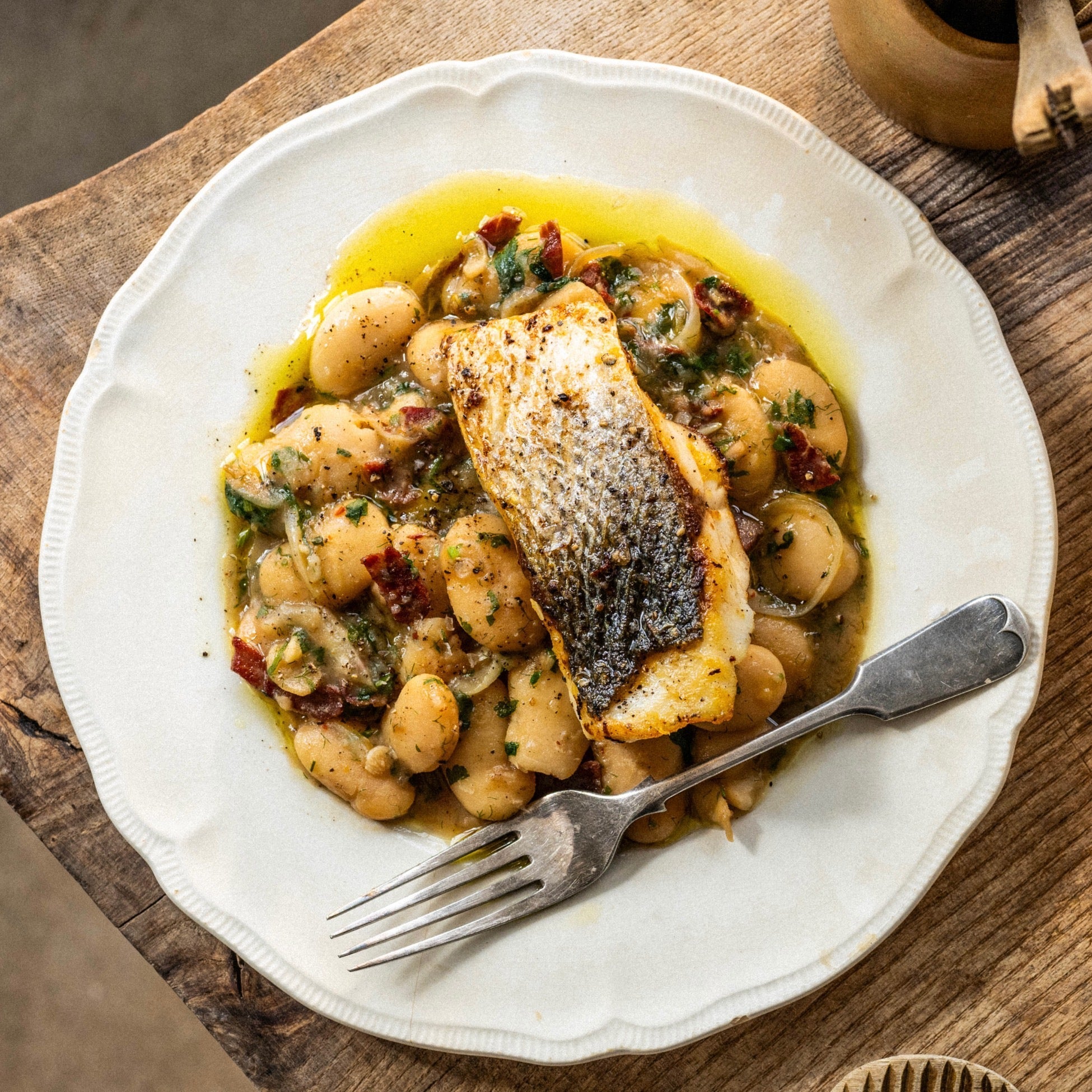 Sea bass with butter beans, ham and parsley