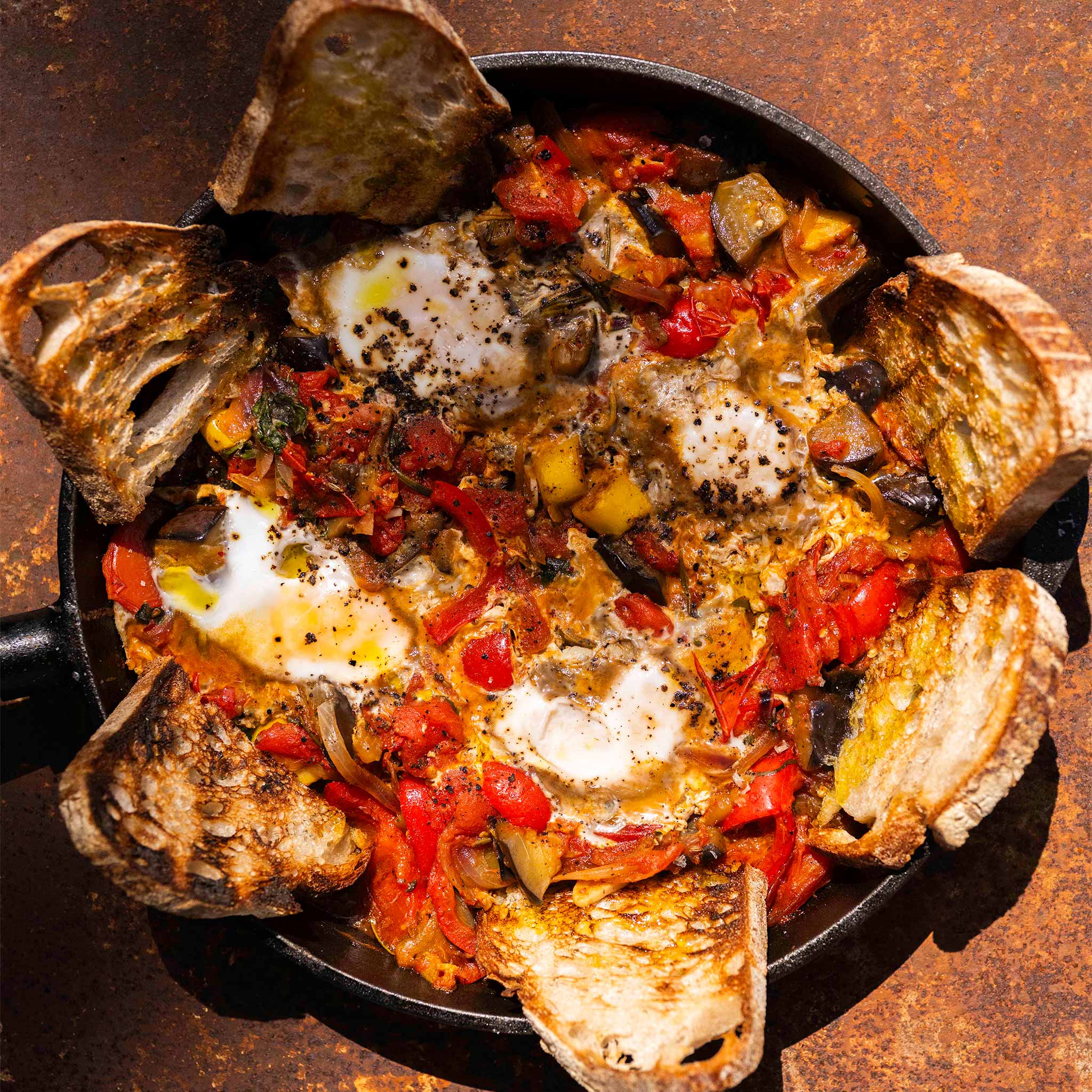 Ratatouille baked eggs with grilled toasts