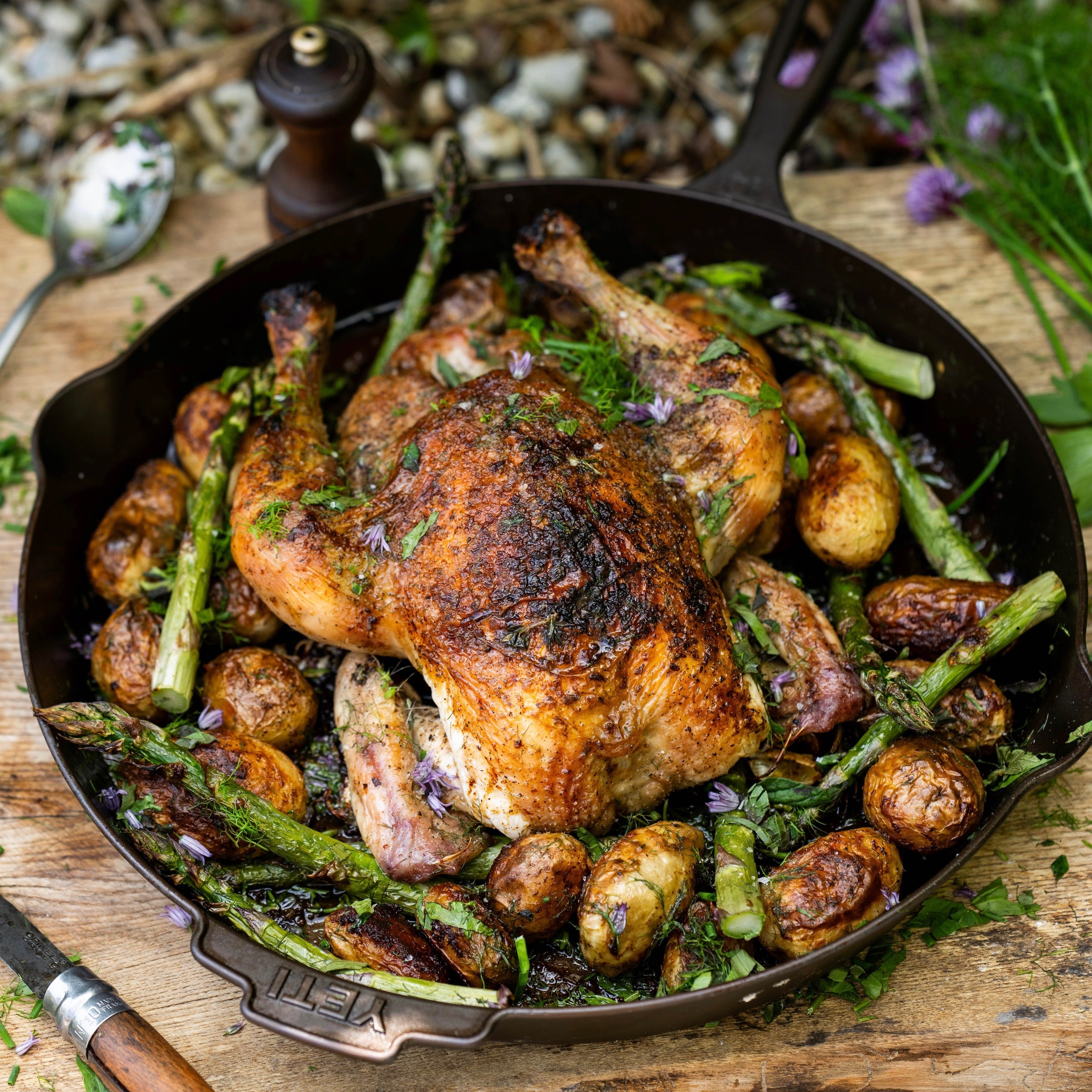 Roast chicken with new potatoes, asparagus and garden herbs