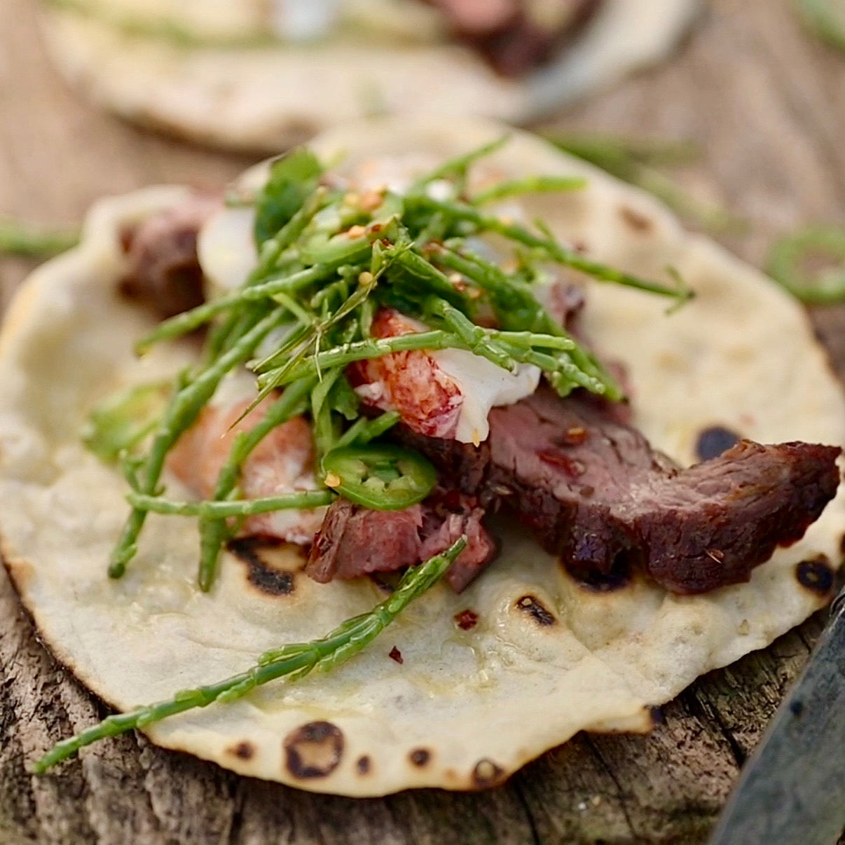 Bavette steak and lobster tacos with samphire and green chilli