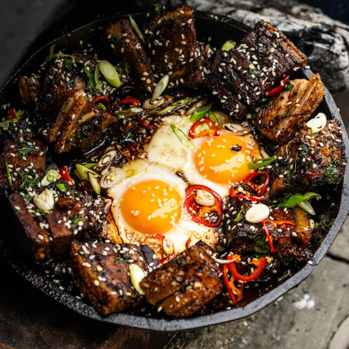 Soy and ginger roast pork belly with chilli, spring onion and sesame fried eggs
