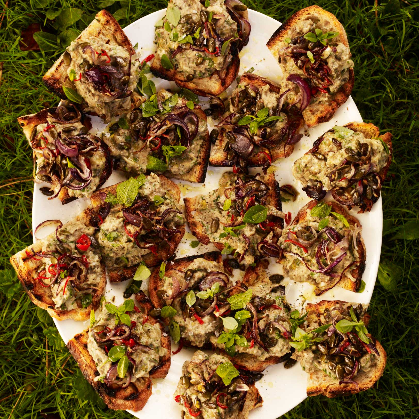 Aubergine on toast with basil, pumpkin seeds and chilli