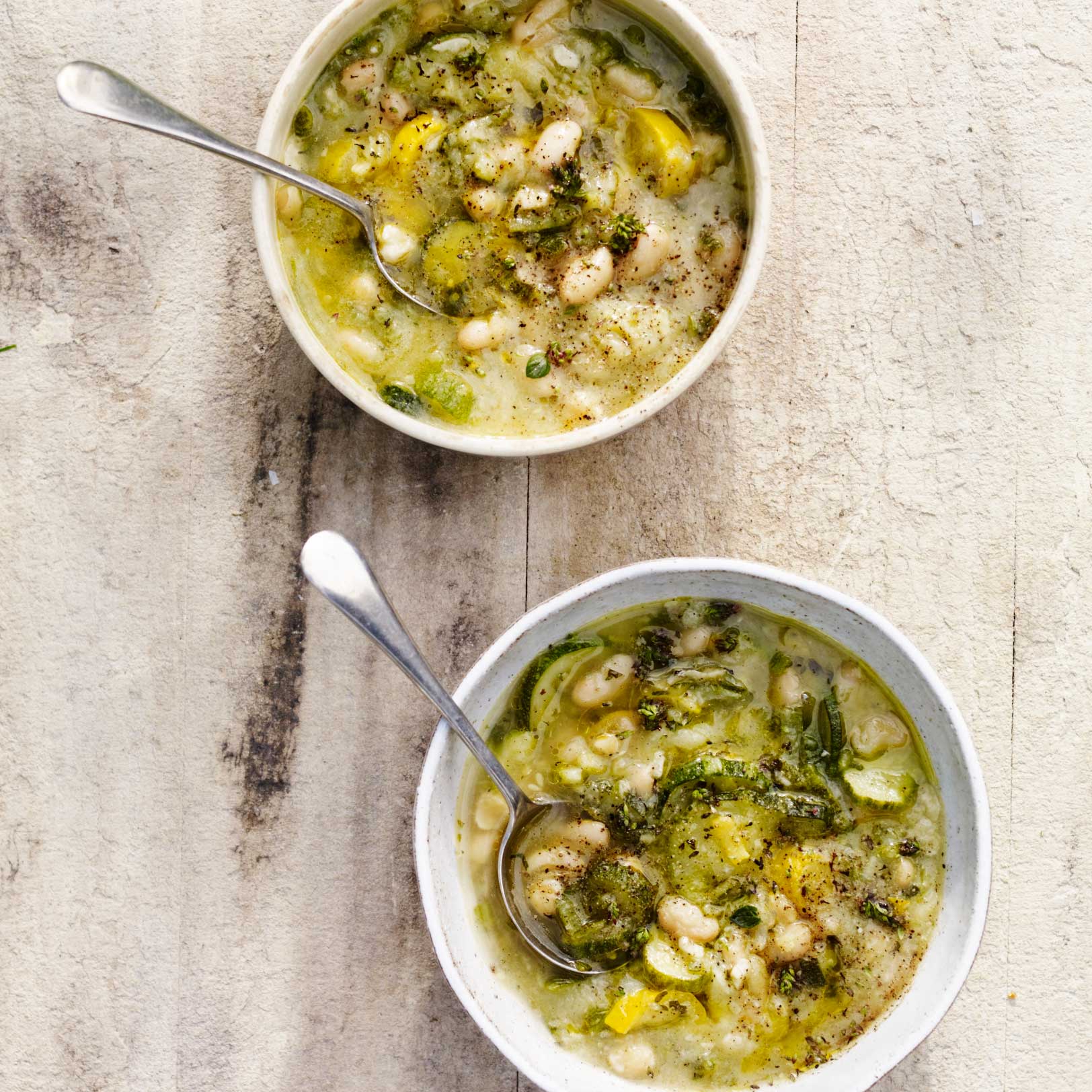Courgette and bean soup with marjoram, garlic and hazelnuts