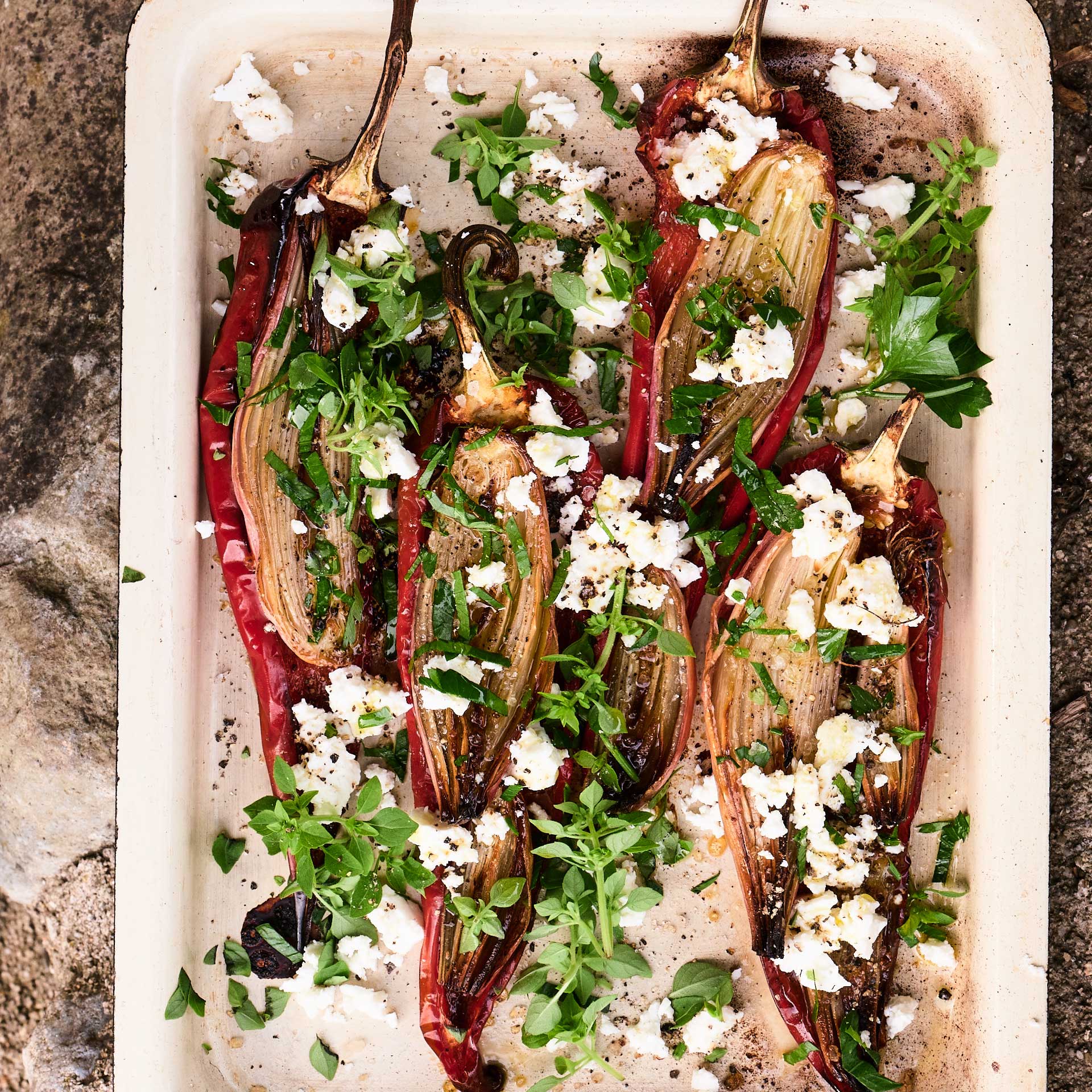 Roast peppers and shallots with basil, parsley and feta cheese