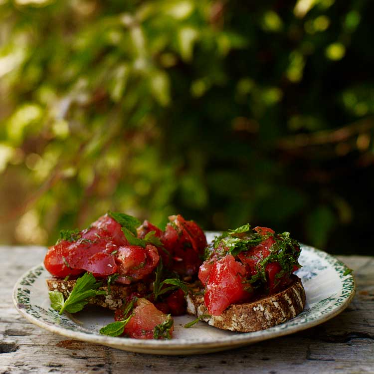 Tomatoes on toast with olive oil, mint and lovage