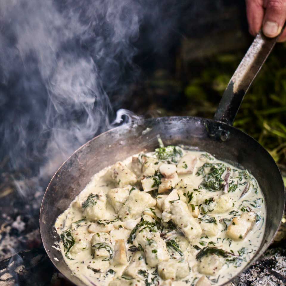 Smoky fish with spinach, gnocchi, cream and mustard