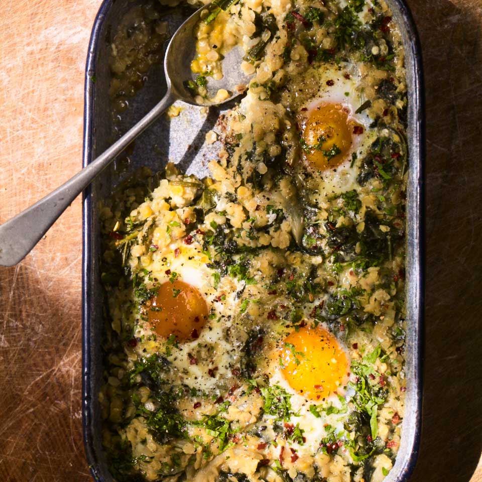 Lentils cooked with garlic, chilli and rosemary with baked eggs and kale