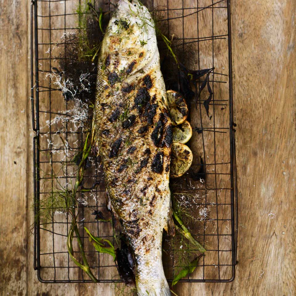 A whole fish cooked over the fire