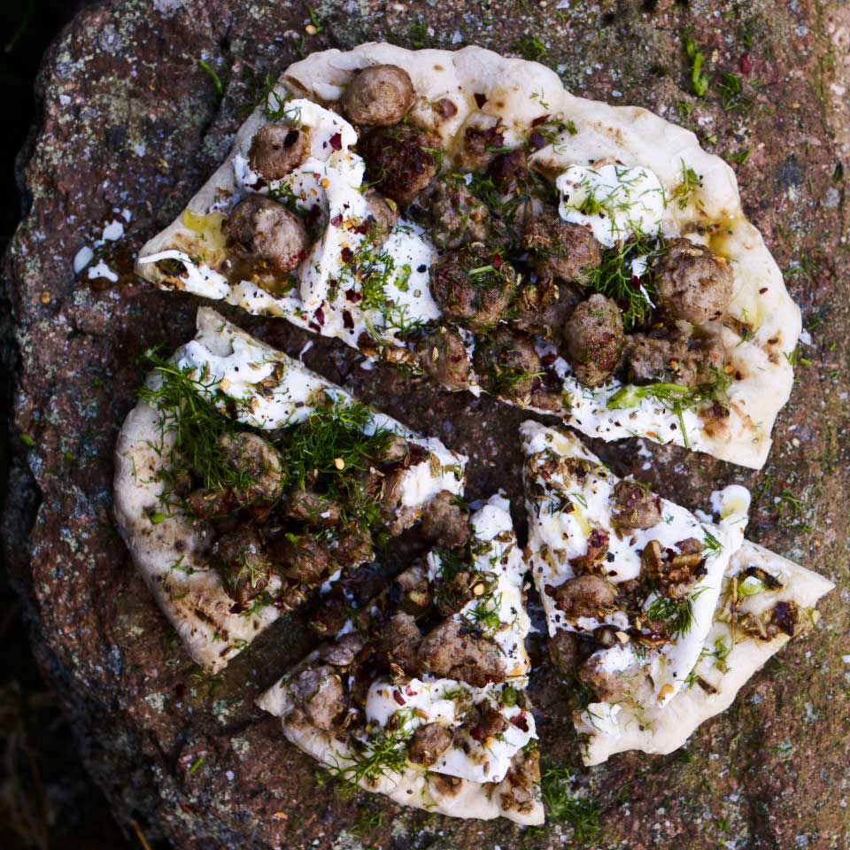 Flat breads with chilli and fennel sausage, burrata and herbs