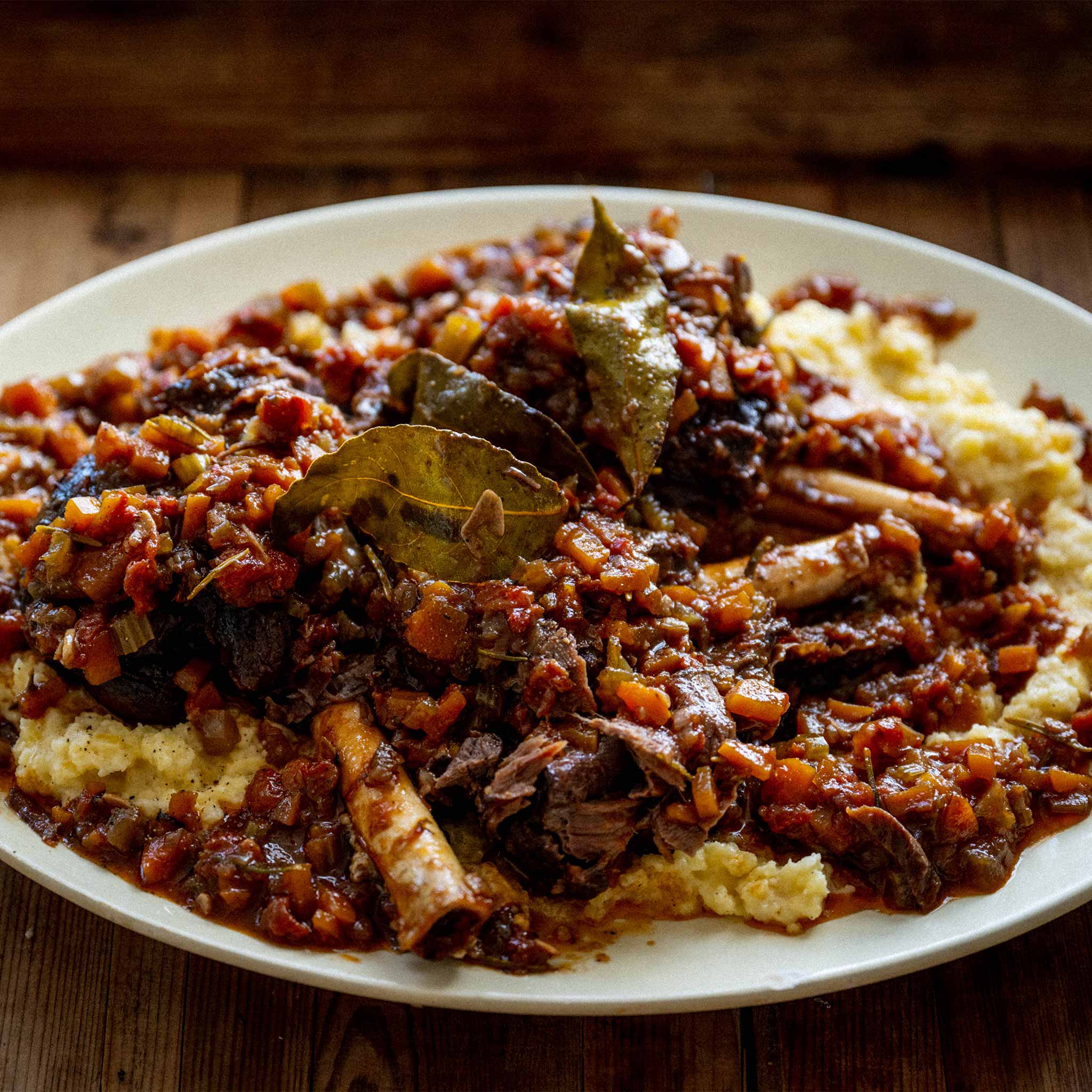 Slow cooked mutton shanks in red wine with bashed swede