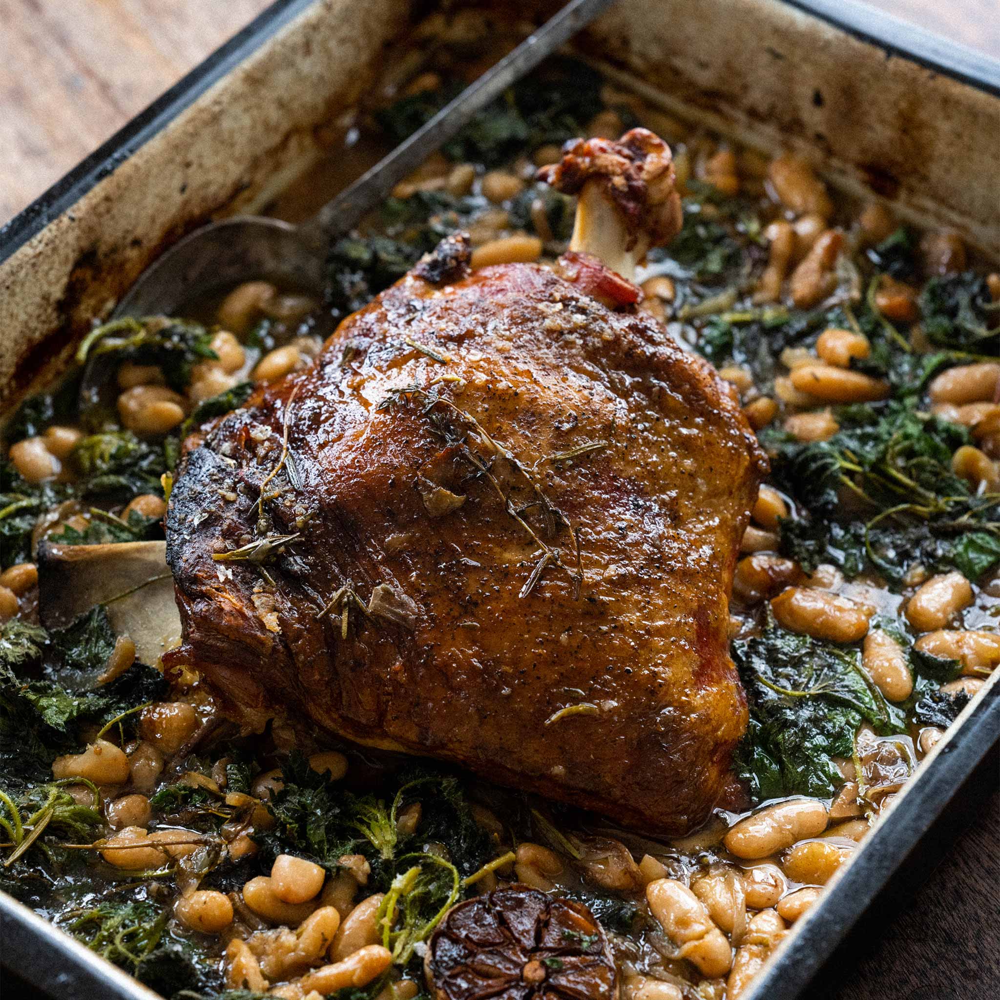 Whole baked shoulder of lamb with white beans and nettles