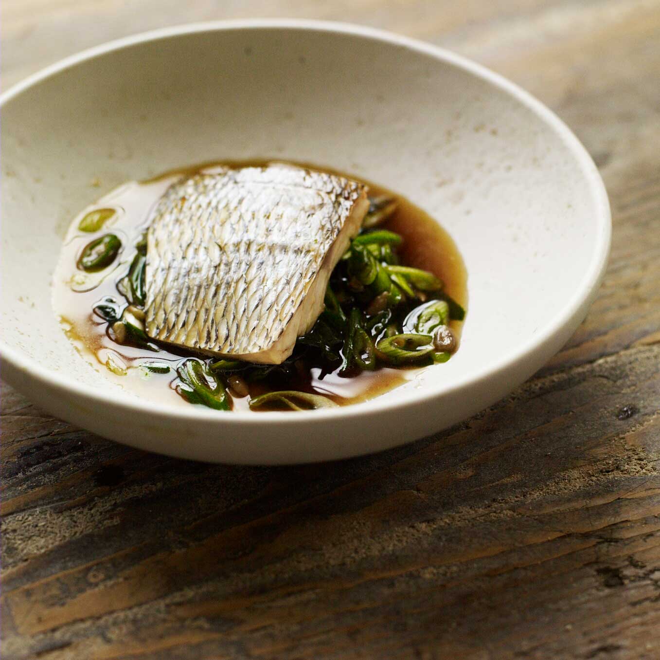 Poached fish with seaweed, ginger & spring onions