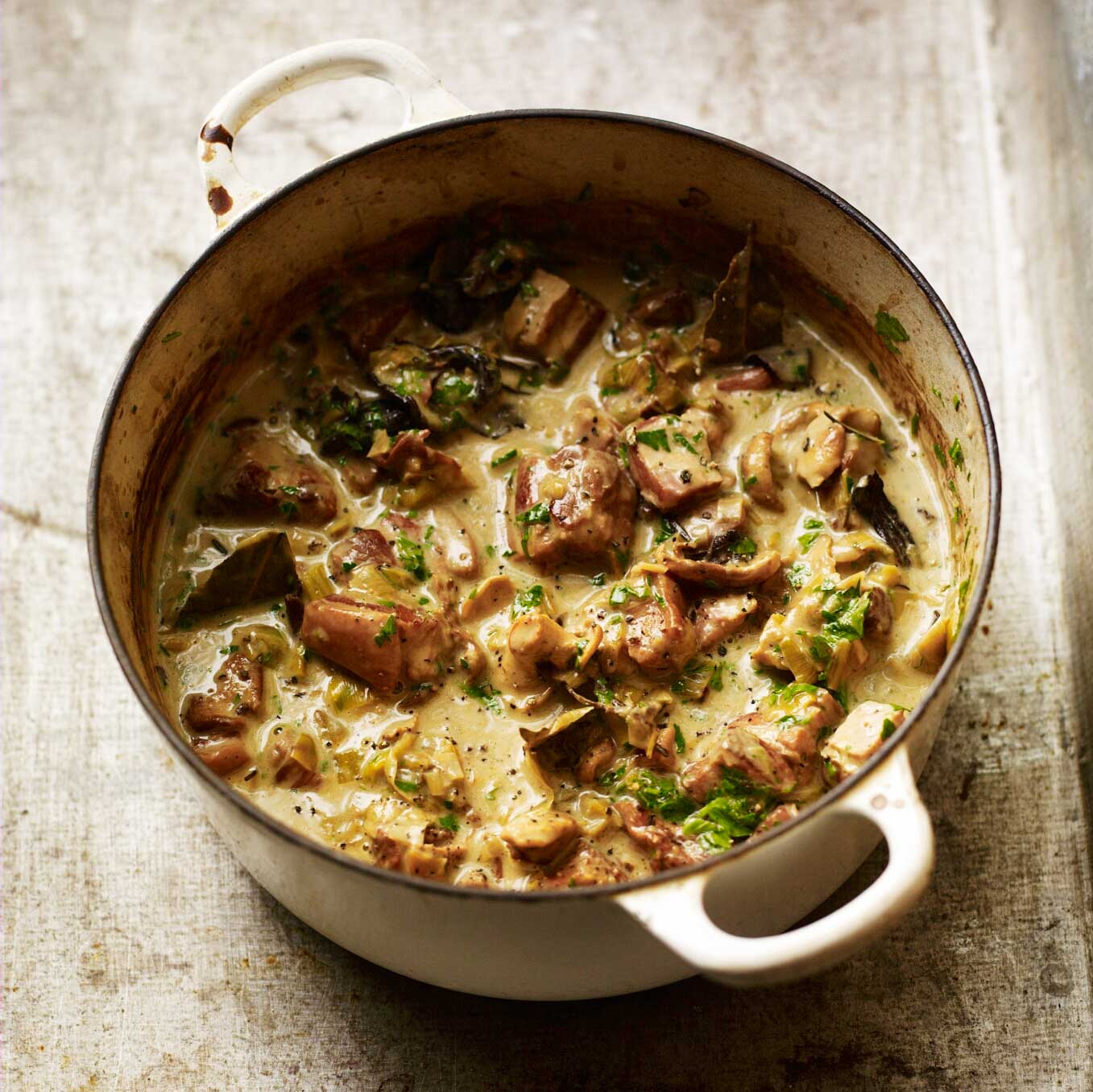 A stew of pork, bacon & mushrooms with cream, cider & parsley