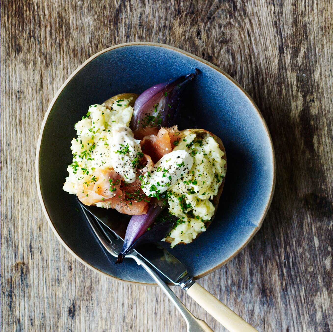 Buttered jacket potatoes with smoked trout, red onions, horseradish & chives