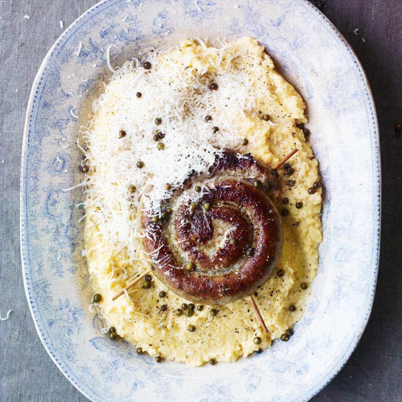 Smashed swede with fried sausage, green peppercorns & parmesan