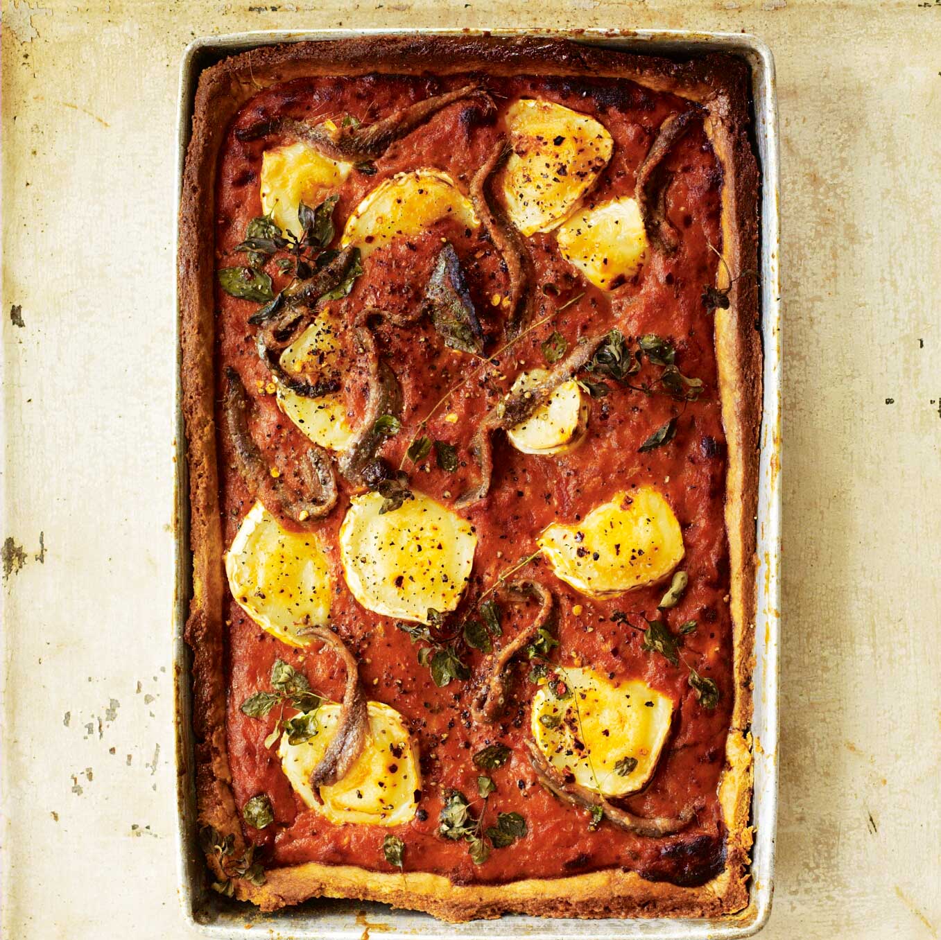 Tomato & anchovy tart with goat’s cheese, marjoram & chilli
