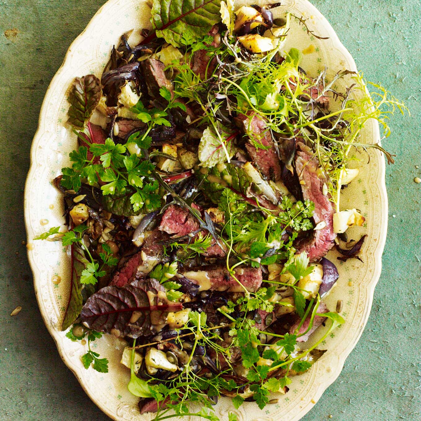 Warm salad of seared skirt steak, roast celeriac, red onions & herbs