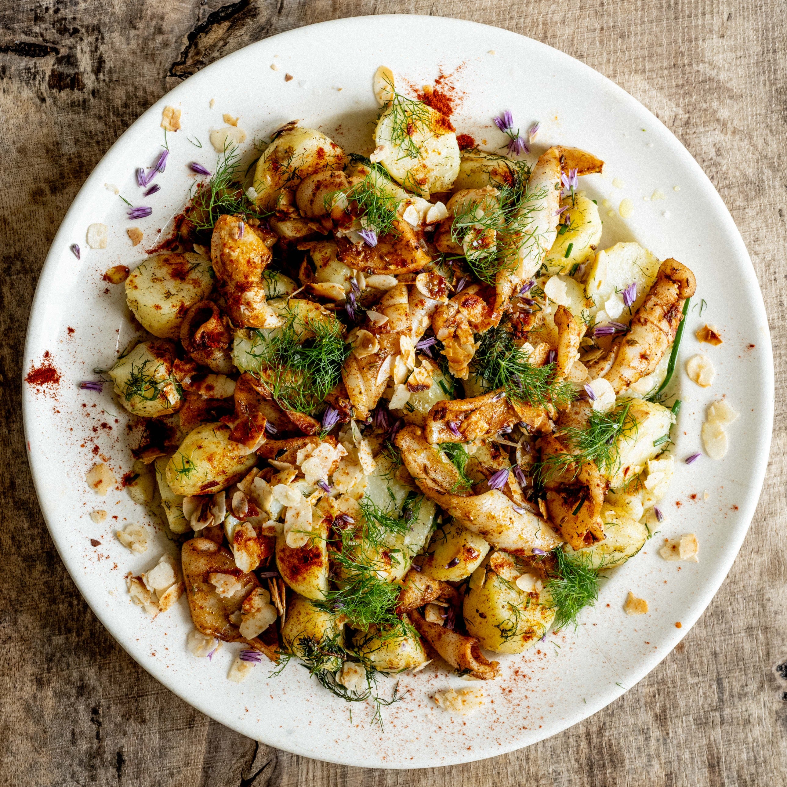 Seared squid with garlic, lemon, smoked paprika, new potatoes and lots of herbs