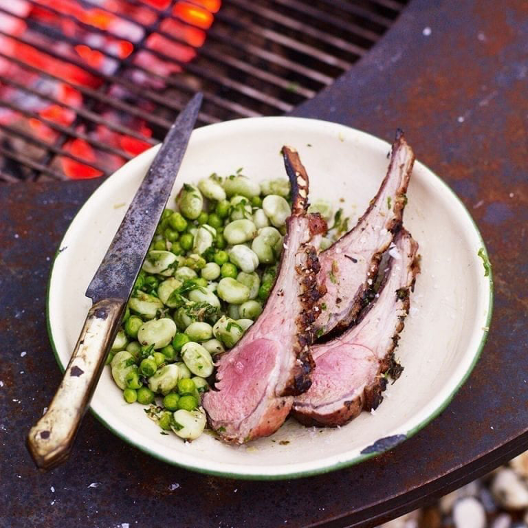 Barbecued rack of lamb with broad beans, peas and lovage